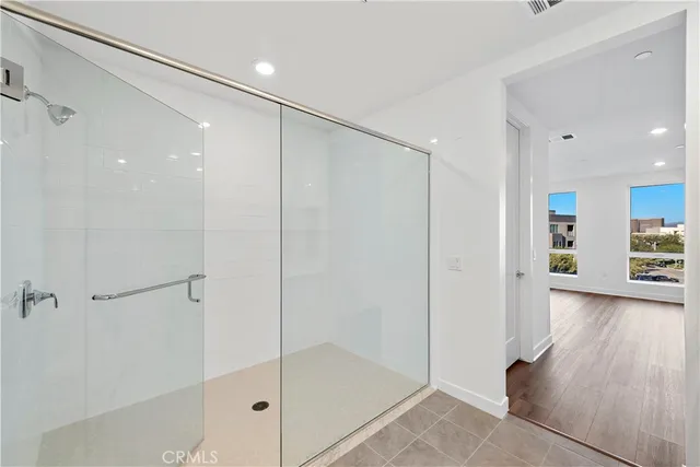 a bathroom with a glass shower door