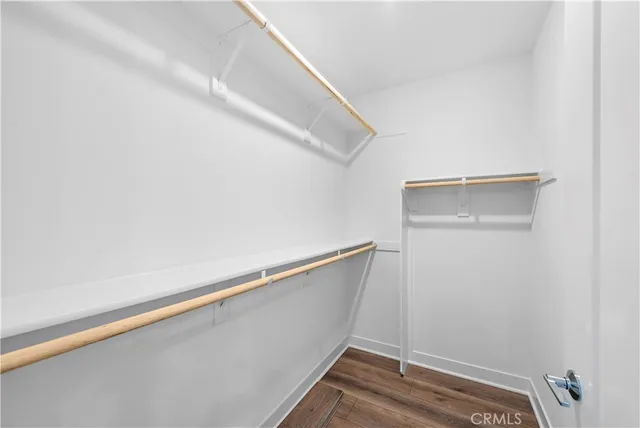 a view of closet with wooden floor