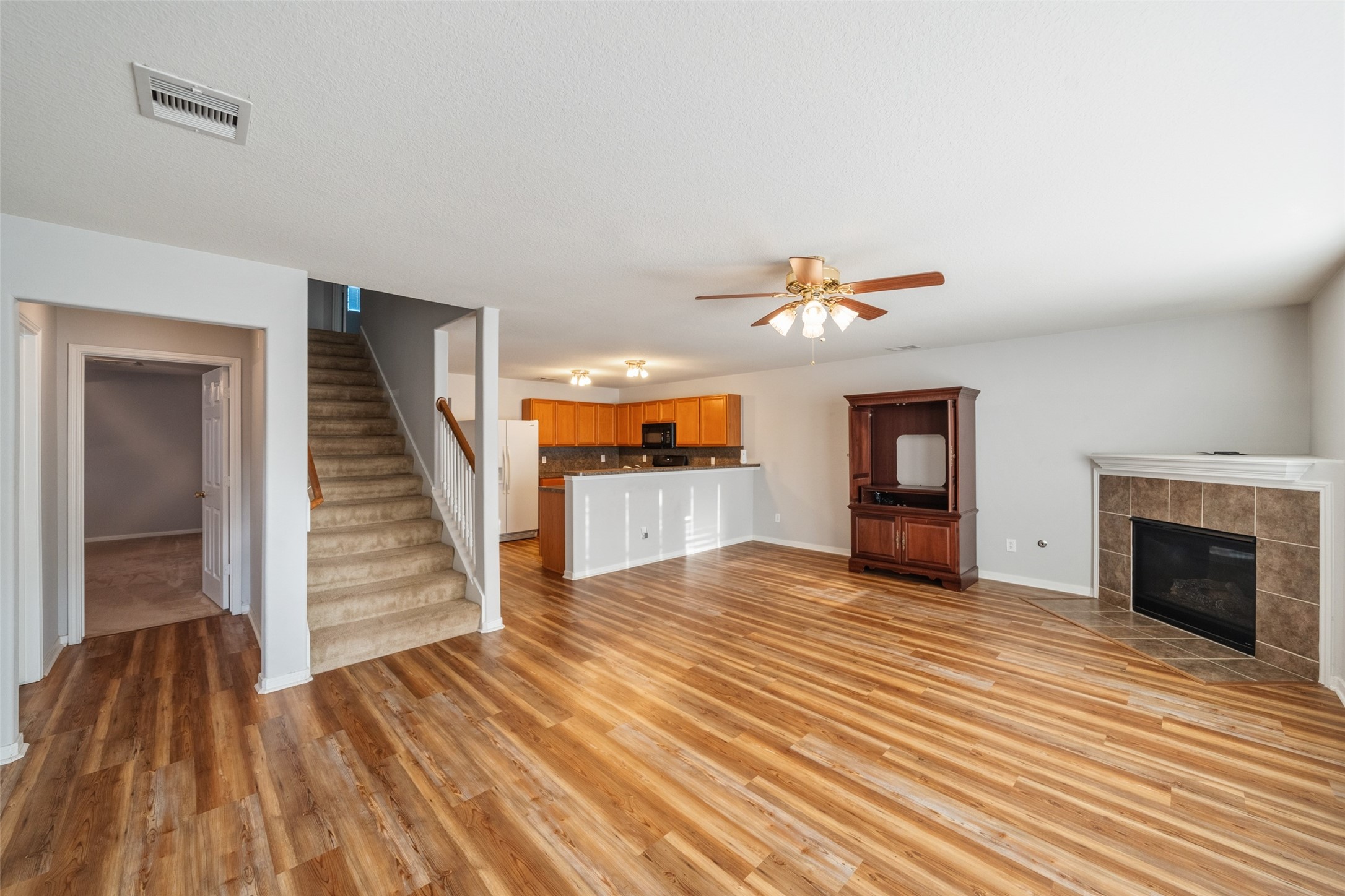 16820 Infield Court Conroe, TX 77385 - Photo 18 of 44 wooden floor in an empty room with a fireplace