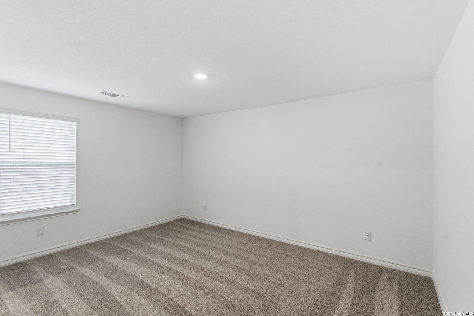 10107 Monte Carmel Place Adkins, TX 78101 - Photo 12 of 25 an empty room with a window