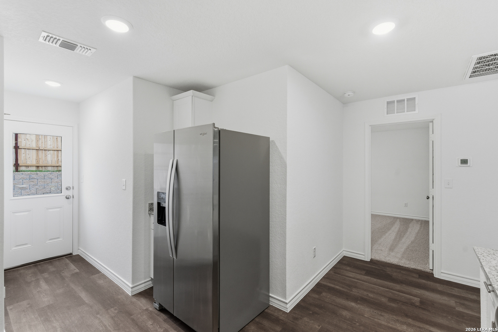 10107 Monte Carmel Place Adkins, TX 78101 - Photo 18 of 25 an empty room with wooden floor and windows