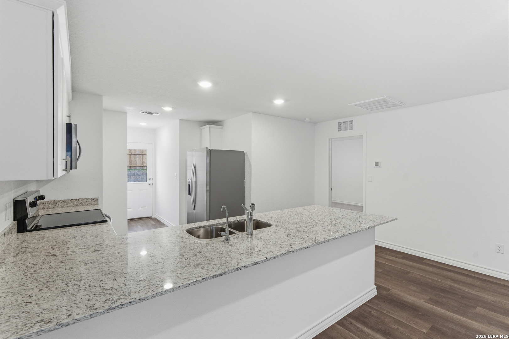 10107 Monte Carmel Place Adkins, TX 78101 - Photo 3 of 25 a bathroom with a granite countertop sink and a large mirror