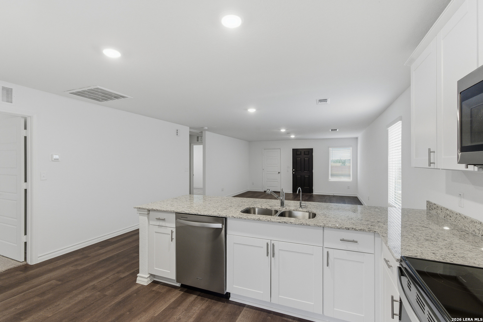 10107 Monte Carmel Place Adkins, TX 78101 - Photo 9 of 25 a kitchen with sink stove and cabinets