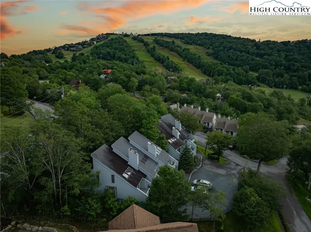 an aerial view of a house with mountain view