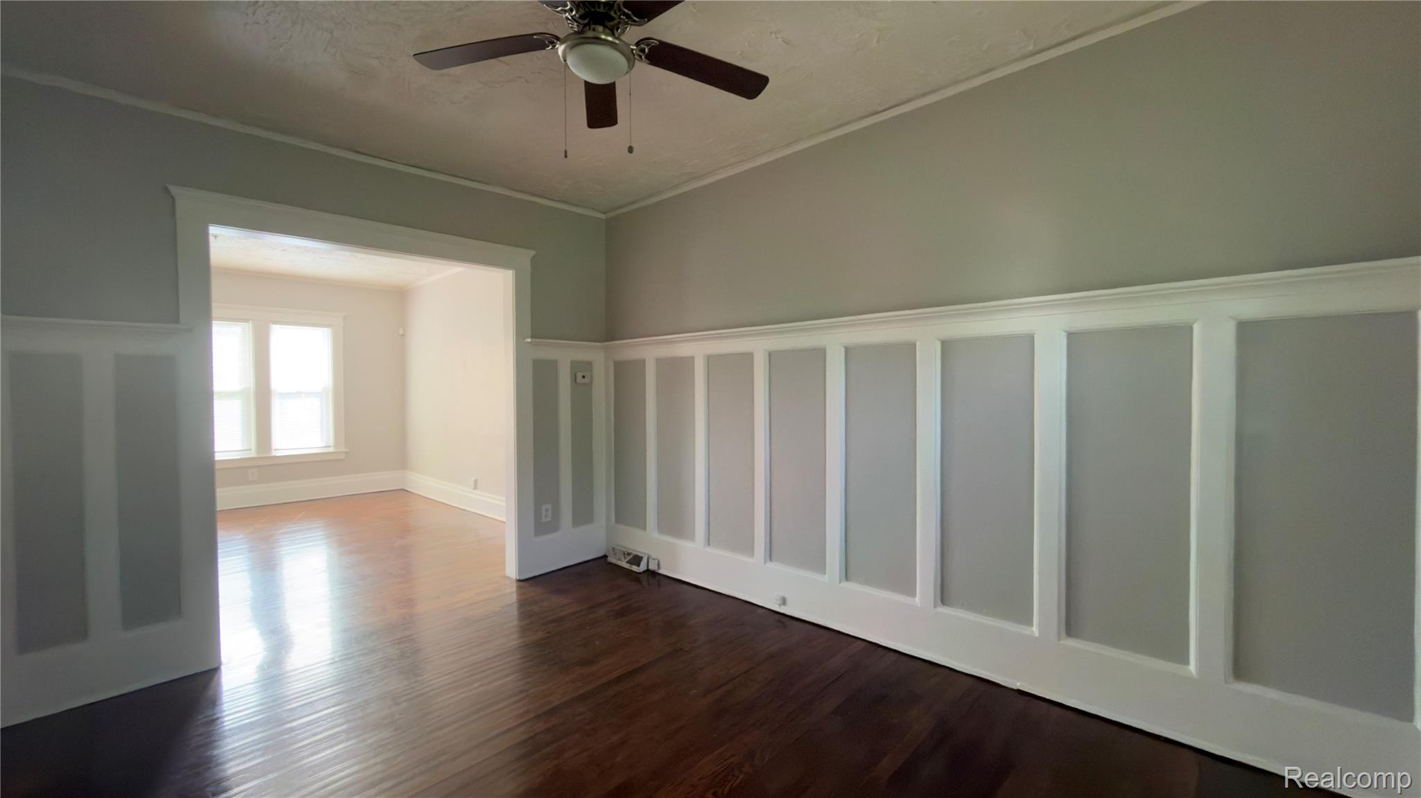 9426 John R Street Detroit, MI 48202 - Photo 10 of 17 Hardwood flooring paired with wainscoting and crown molding throughout