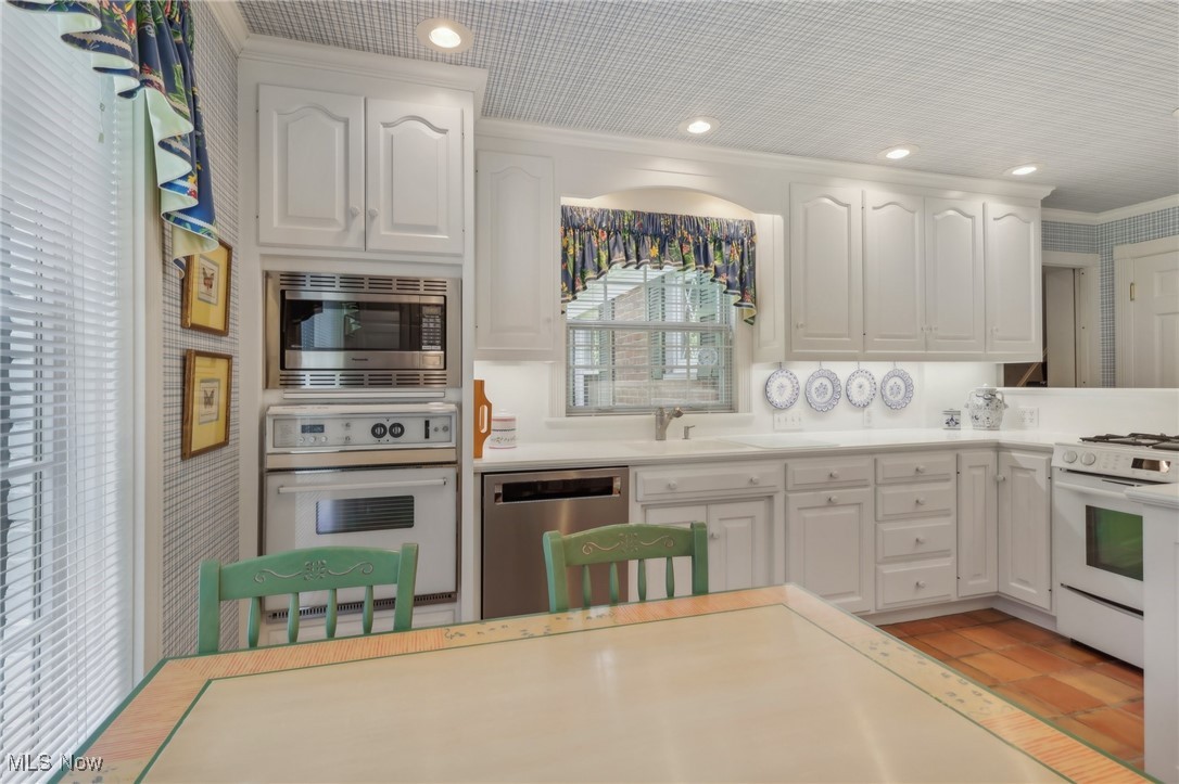 2060 Stockbridge Road Akron, OH 44313 - Photo 15 of 41 Kitchen with ornamental molding, sink, stainless steel appliances, and white cabinets
