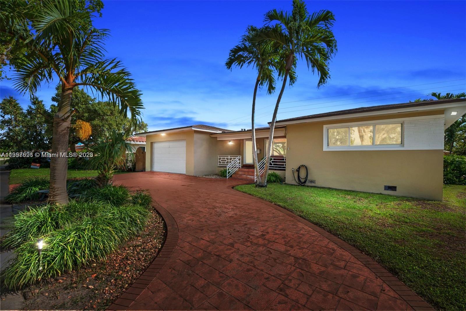 307 North Rainbow Drive Hollywood, FL 33021 - Photo 3 of 74 a front view of a house with a yard and garage