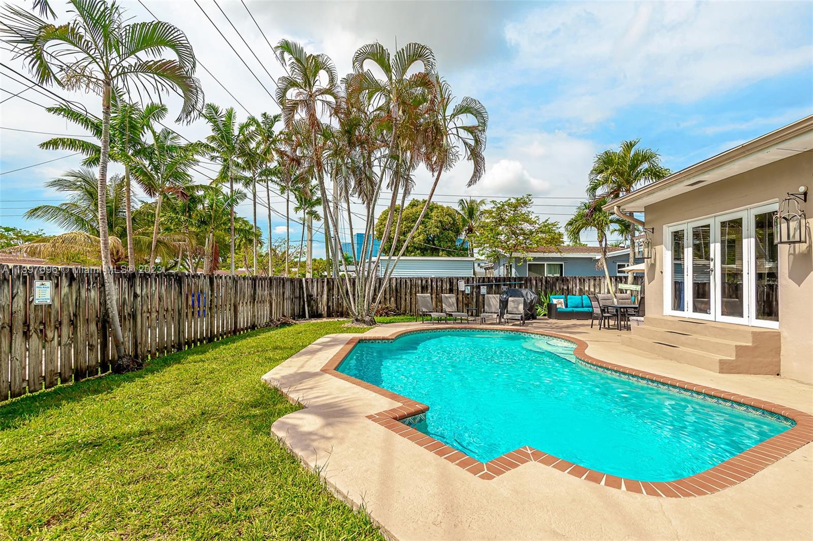 307 North Rainbow Drive Hollywood, FL 33021 - Photo 40 of 74 a view of a swimming pool with a lounge chairs