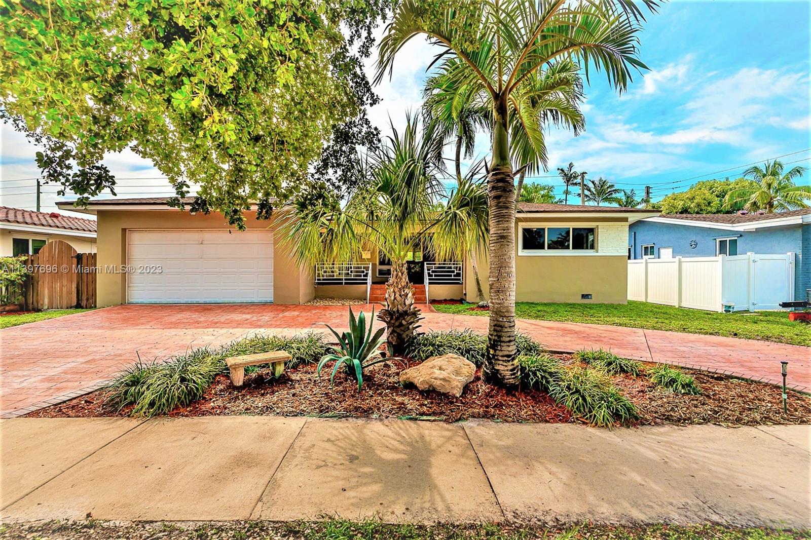 307 North Rainbow Drive Hollywood, FL 33021 - Photo 4 of 74 a front view of a house with a garden