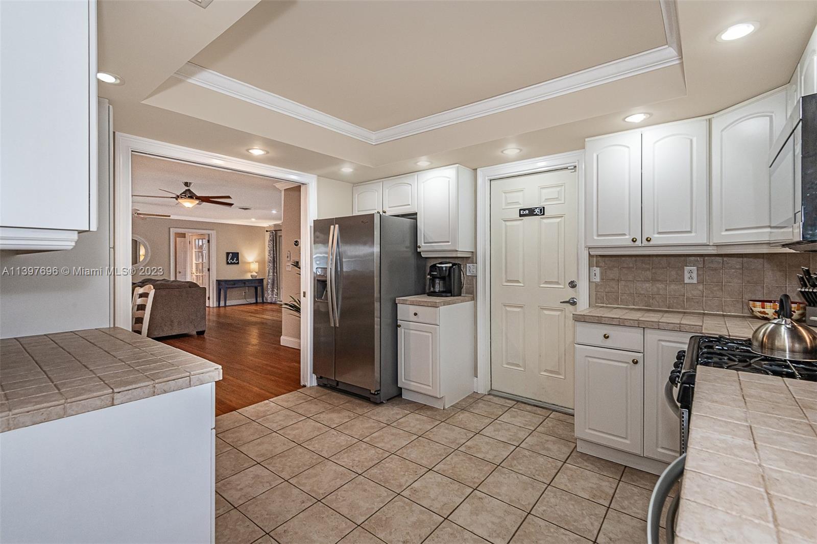 307 North Rainbow Drive Hollywood, FL 33021 - Photo 51 of 74 a kitchen with granite countertop a refrigerator and a stove top oven