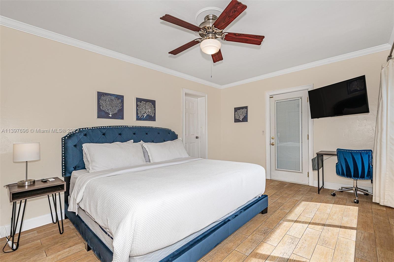 307 North Rainbow Drive Hollywood, FL 33021 - Photo 54 of 74 a bedroom with a large bed a flat tv screen and a ceiling fan