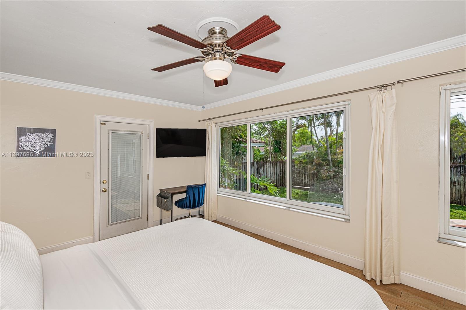 307 North Rainbow Drive Hollywood, FL 33021 - Photo 55 of 74 a bedroom with a bed and a large window with a flat tv screen