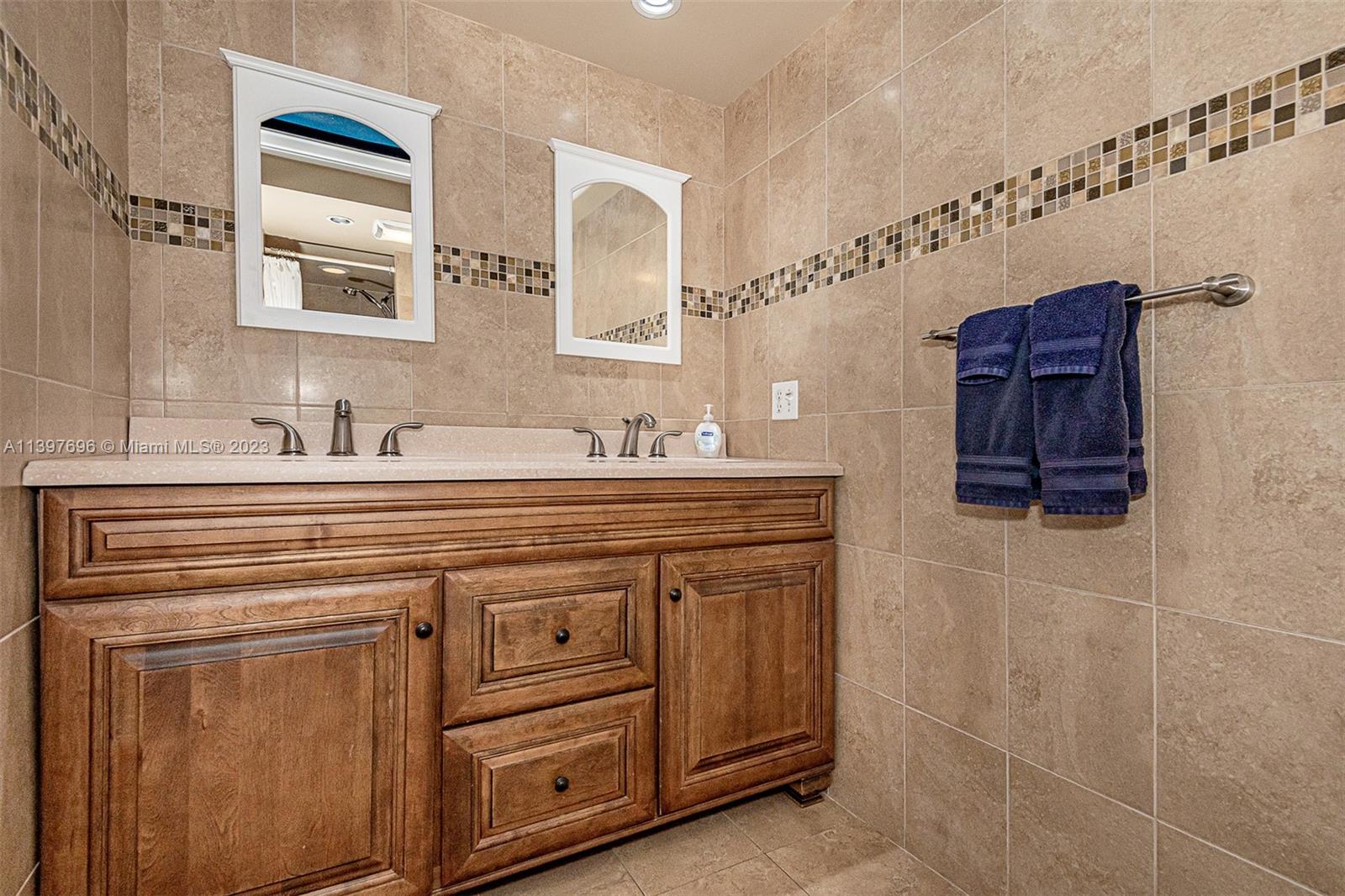 307 North Rainbow Drive Hollywood, FL 33021 - Photo 59 of 74 a bathroom with a sink and a mirror