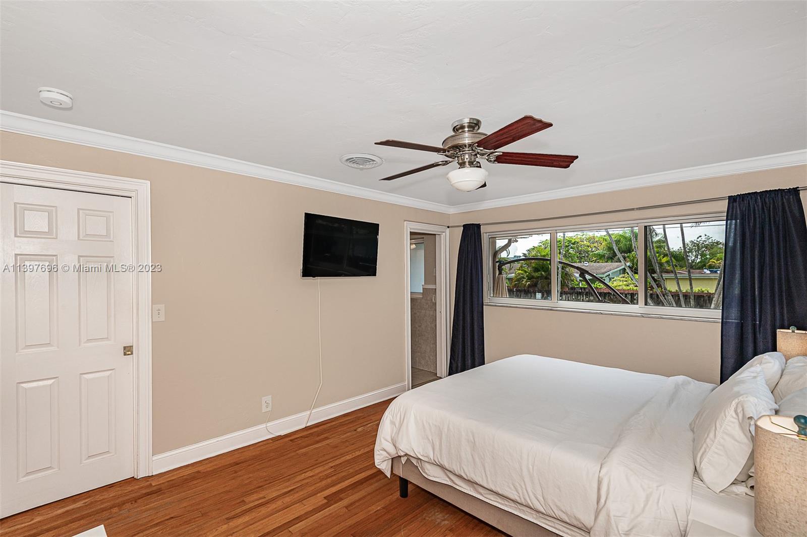 307 North Rainbow Drive Hollywood, FL 33021 - Photo 63 of 74 a bedroom with a large bed and a tv