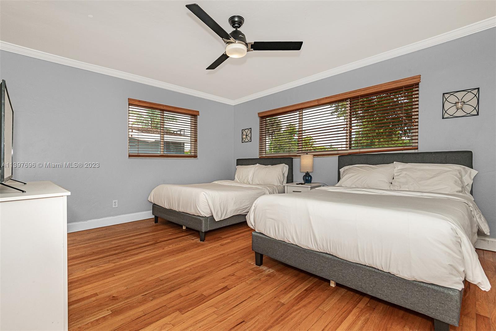307 North Rainbow Drive Hollywood, FL 33021 - Photo 67 of 74 a spacious bedroom with two beds and a ceiling fan