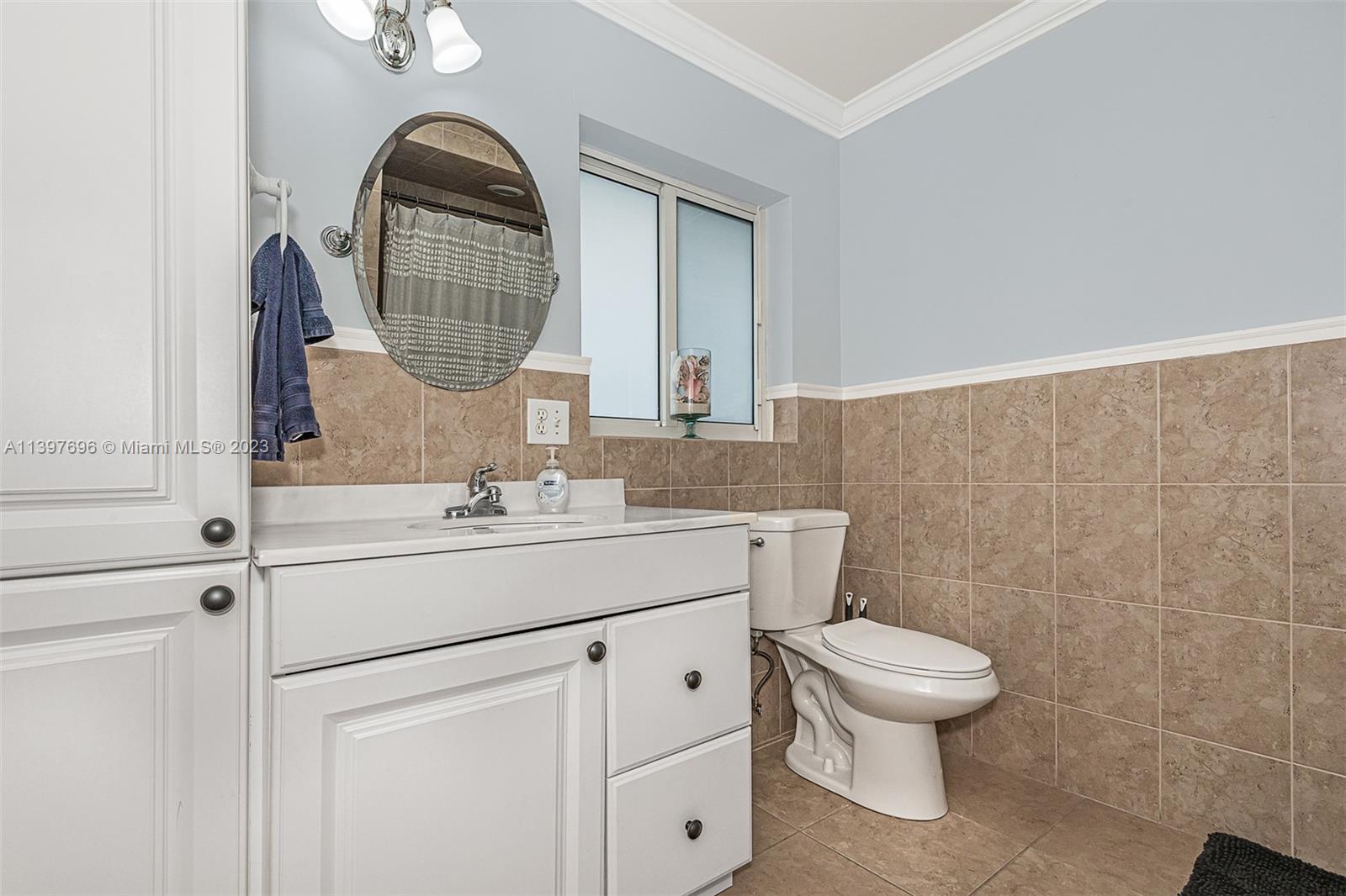 307 North Rainbow Drive Hollywood, FL 33021 - Photo 70 of 74 a bathroom with a toilet sink and mirror