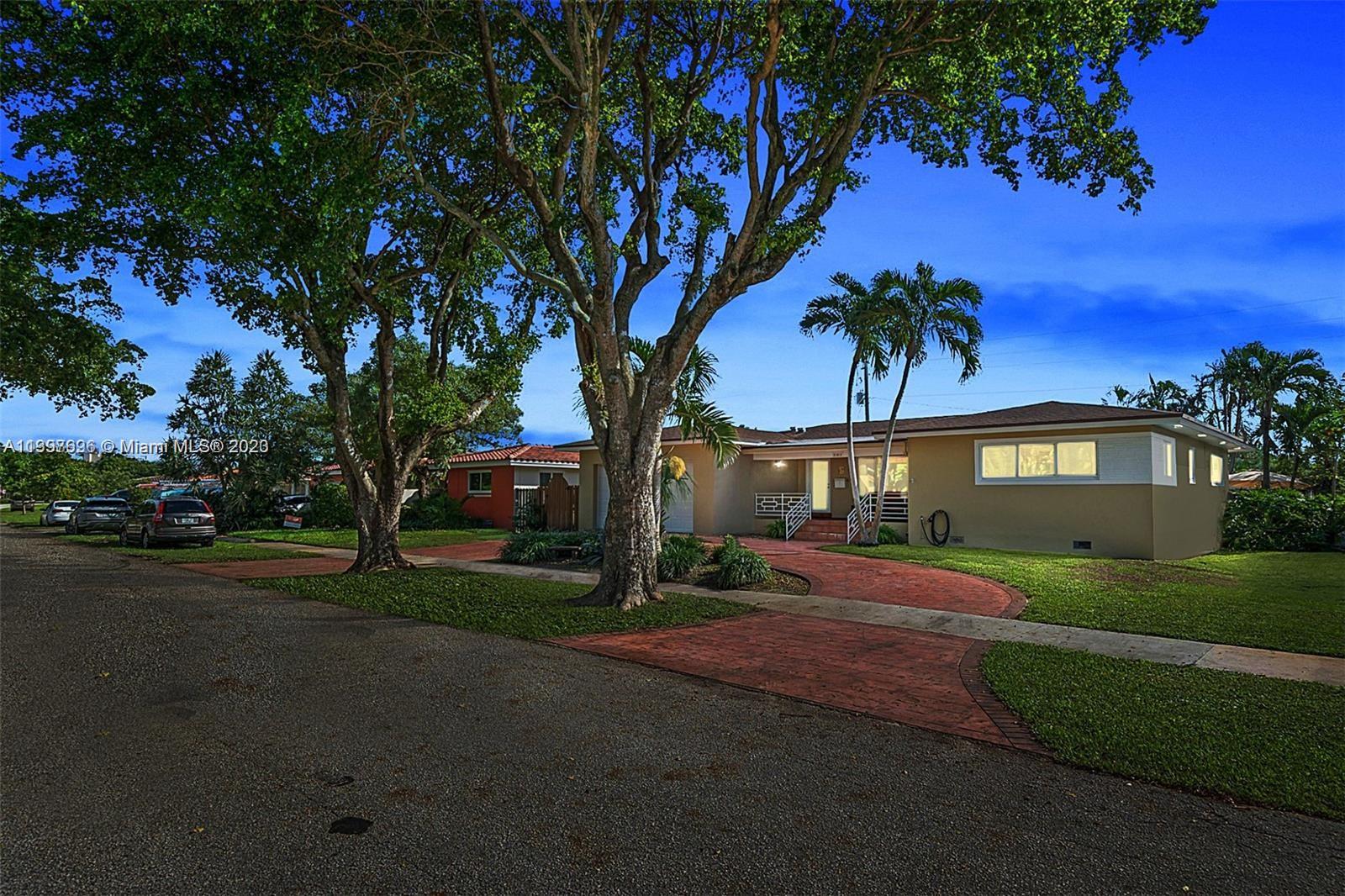 307 North Rainbow Drive Hollywood, FL 33021 - Photo 7 of 74 a front view of a house with a yard and garage
