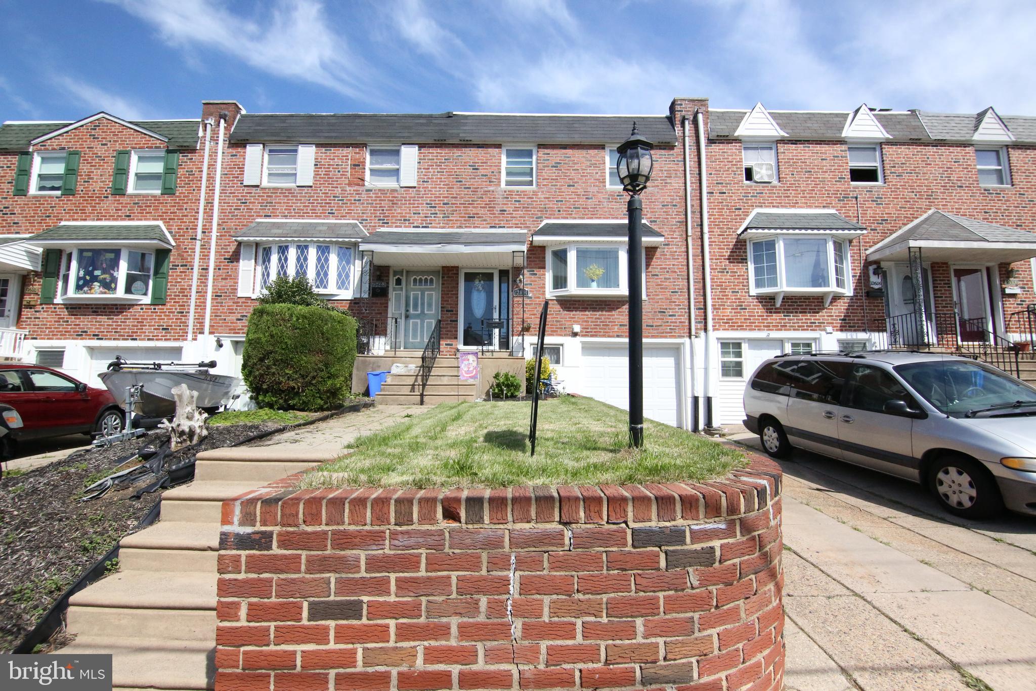 12604 Medford Road Philadelphia, PA 19154 - Photo 1 of 28 a front view of a residential apartment building with a yard