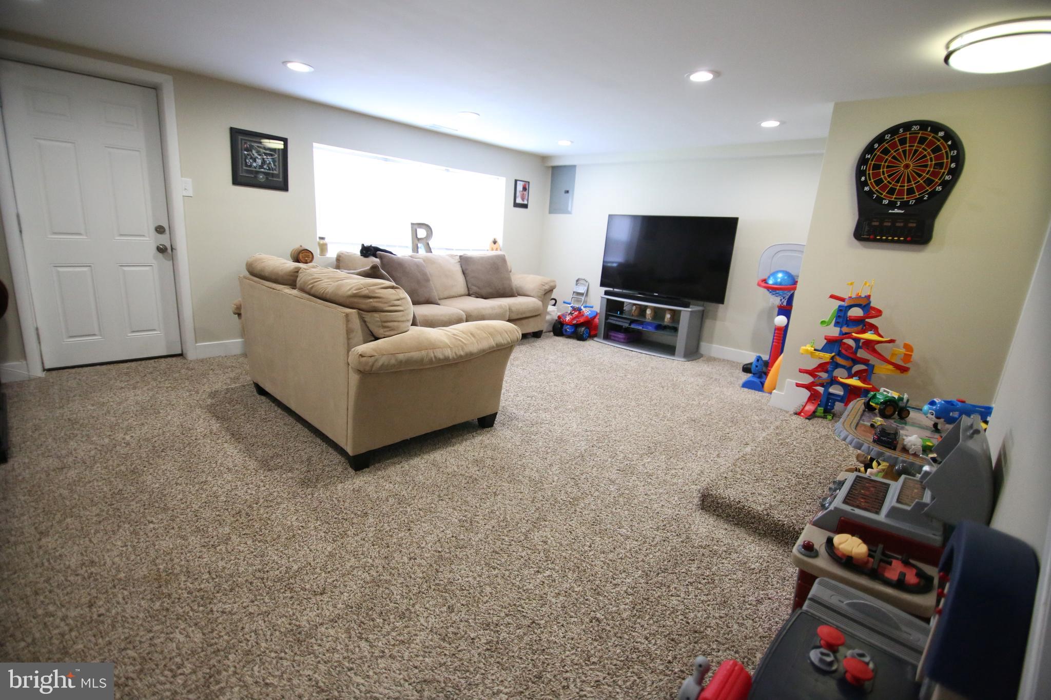 12604 Medford Road Philadelphia, PA 19154 - Photo 11 of 28 a living room with furniture and a flat screen tv