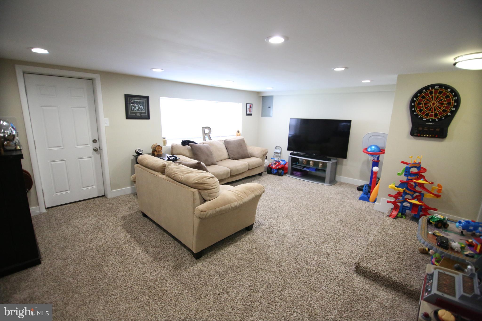 12604 Medford Road Philadelphia, PA 19154 - Photo 12 of 28 a living room with furniture and a flat screen tv
