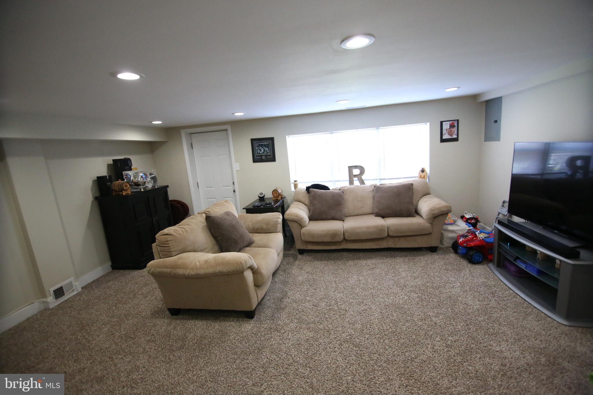 12604 Medford Road Philadelphia, PA 19154 - Photo 15 of 28 a living room with furniture and a flat screen tv