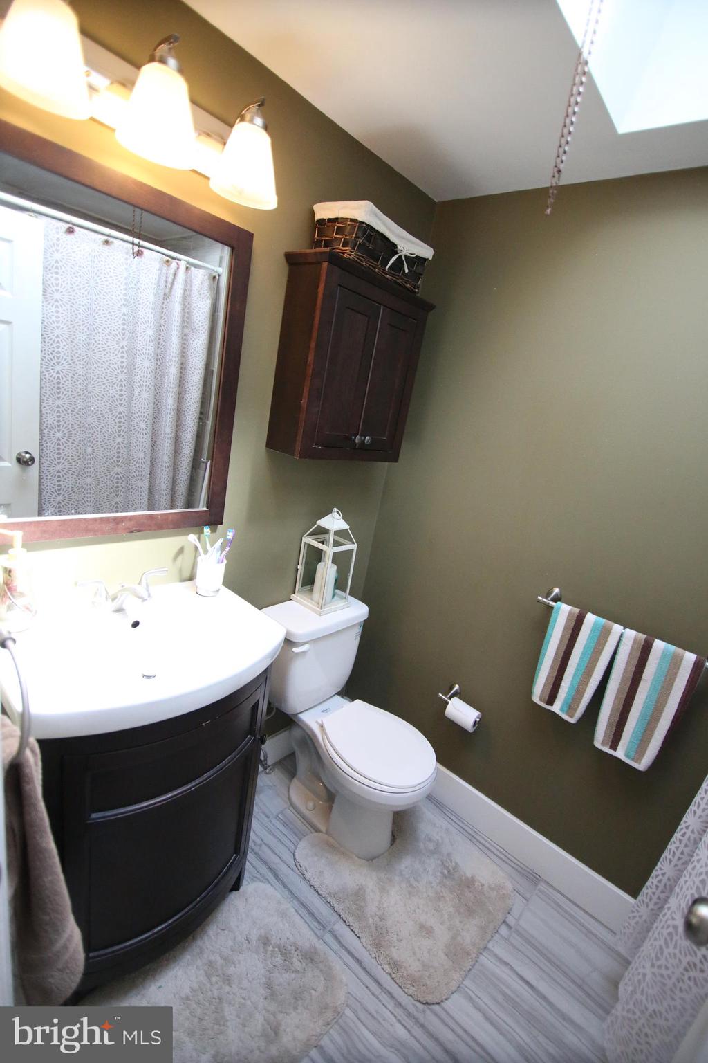12604 Medford Road Philadelphia, PA 19154 - Photo 17 of 28 a bathroom with a sink a toilet and a mirror