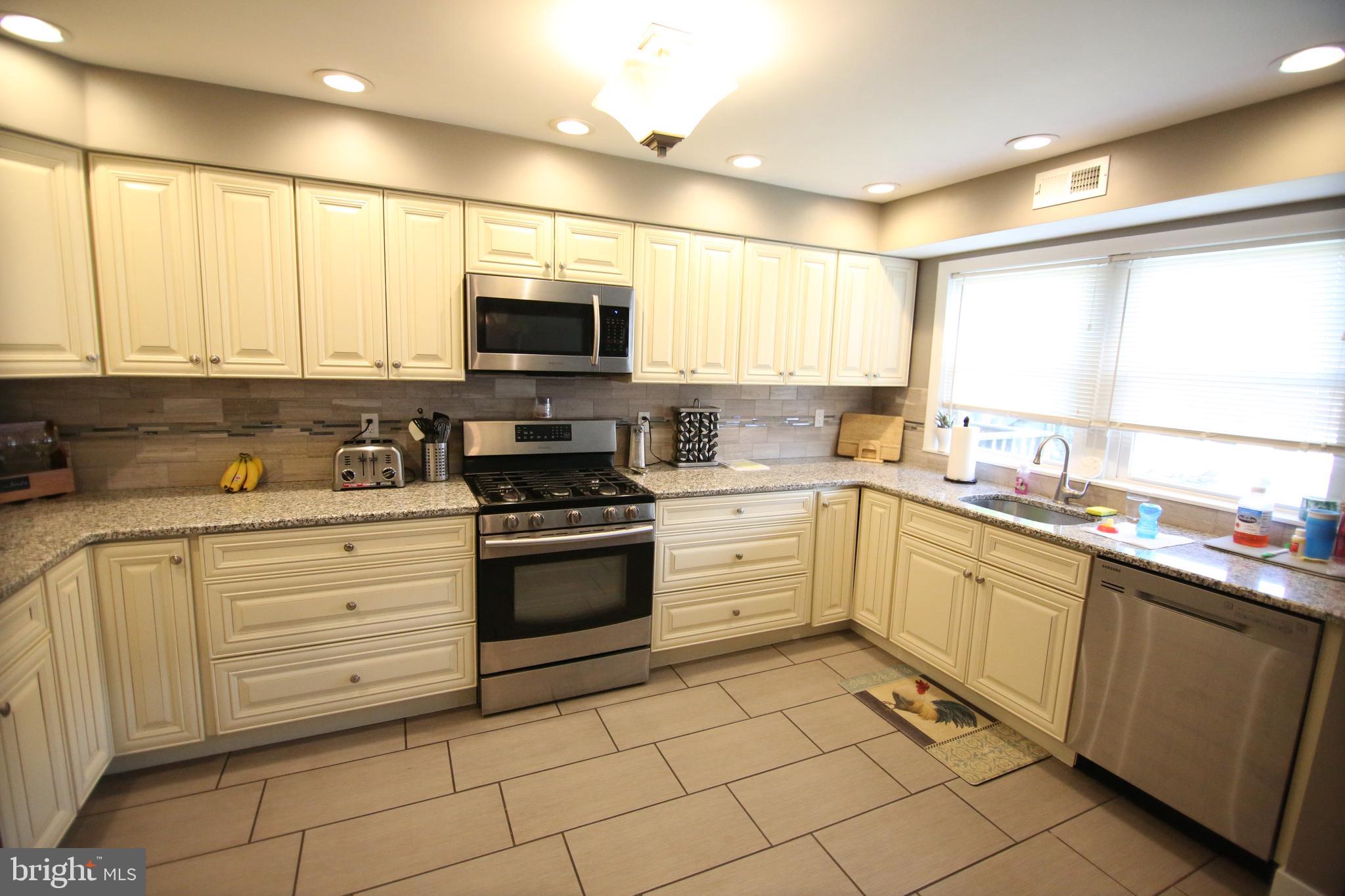 12604 Medford Road Philadelphia, PA 19154 - Photo 5 of 28 a kitchen with stainless steel appliances granite countertop a sink and cabinets