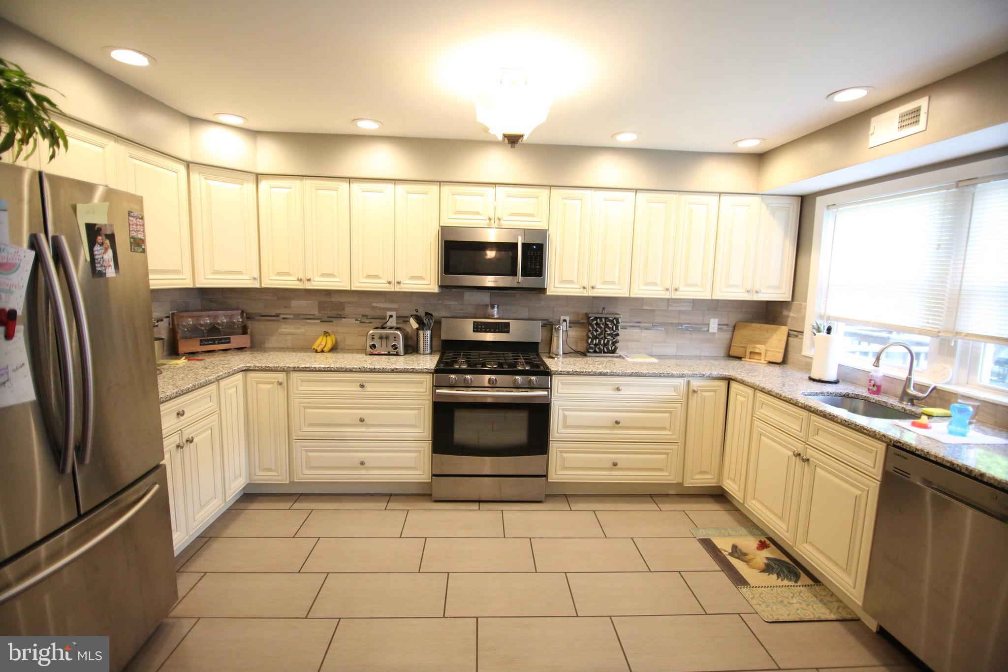 12604 Medford Road Philadelphia, PA 19154 - Photo 6 of 28 a kitchen with a stove a sink and a refrigerator