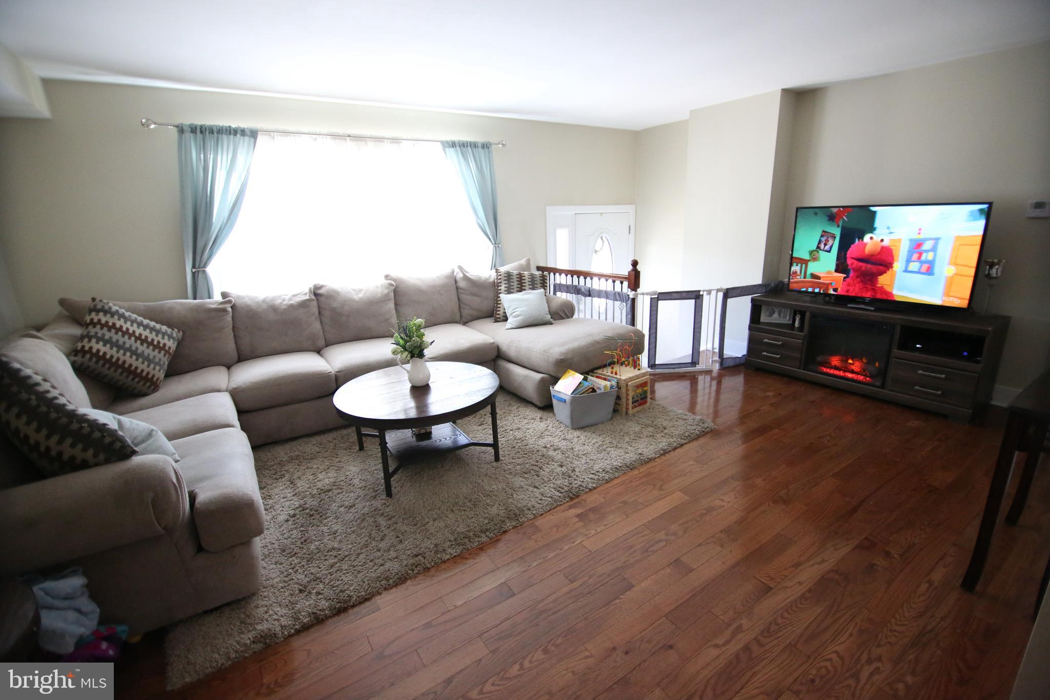 12604 Medford Road Philadelphia, PA 19154 - Photo 10 of 28 a living room with furniture a flat screen tv and a window
