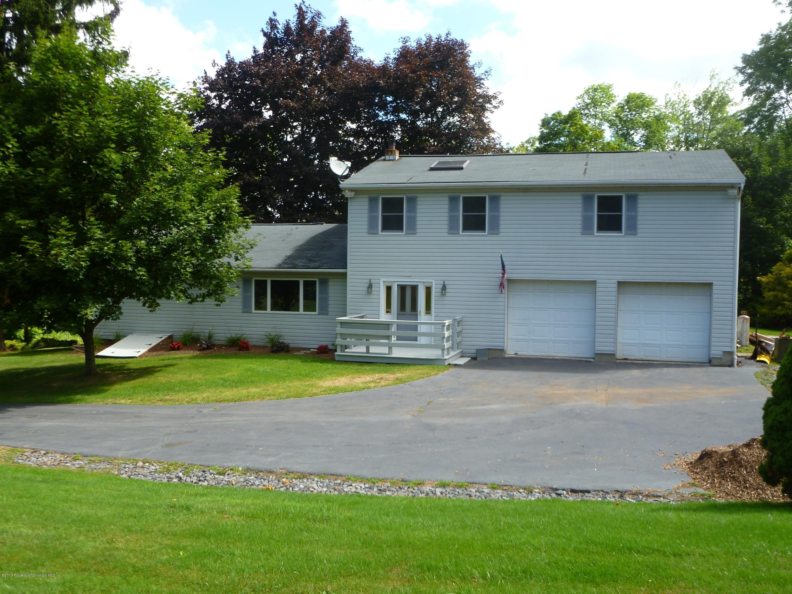 1250 Aberdeen Road Moscow, PA 18444 - Photo 1 of 32 a front view of a house with a yard and porch