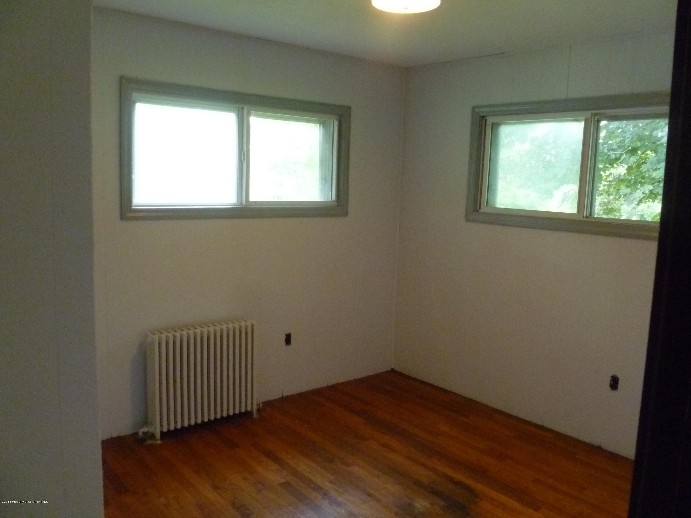 1250 Aberdeen Road Moscow, PA 18444 - Photo 27 of 32 an empty room with wooden floor and windows