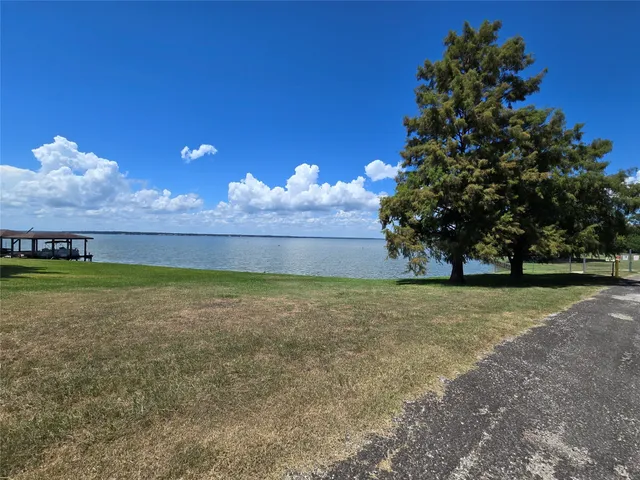a view of a house with a yard garage and sitting area