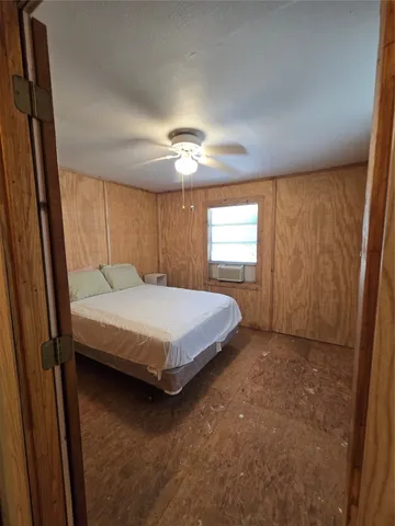 a bedroom with a bed and window