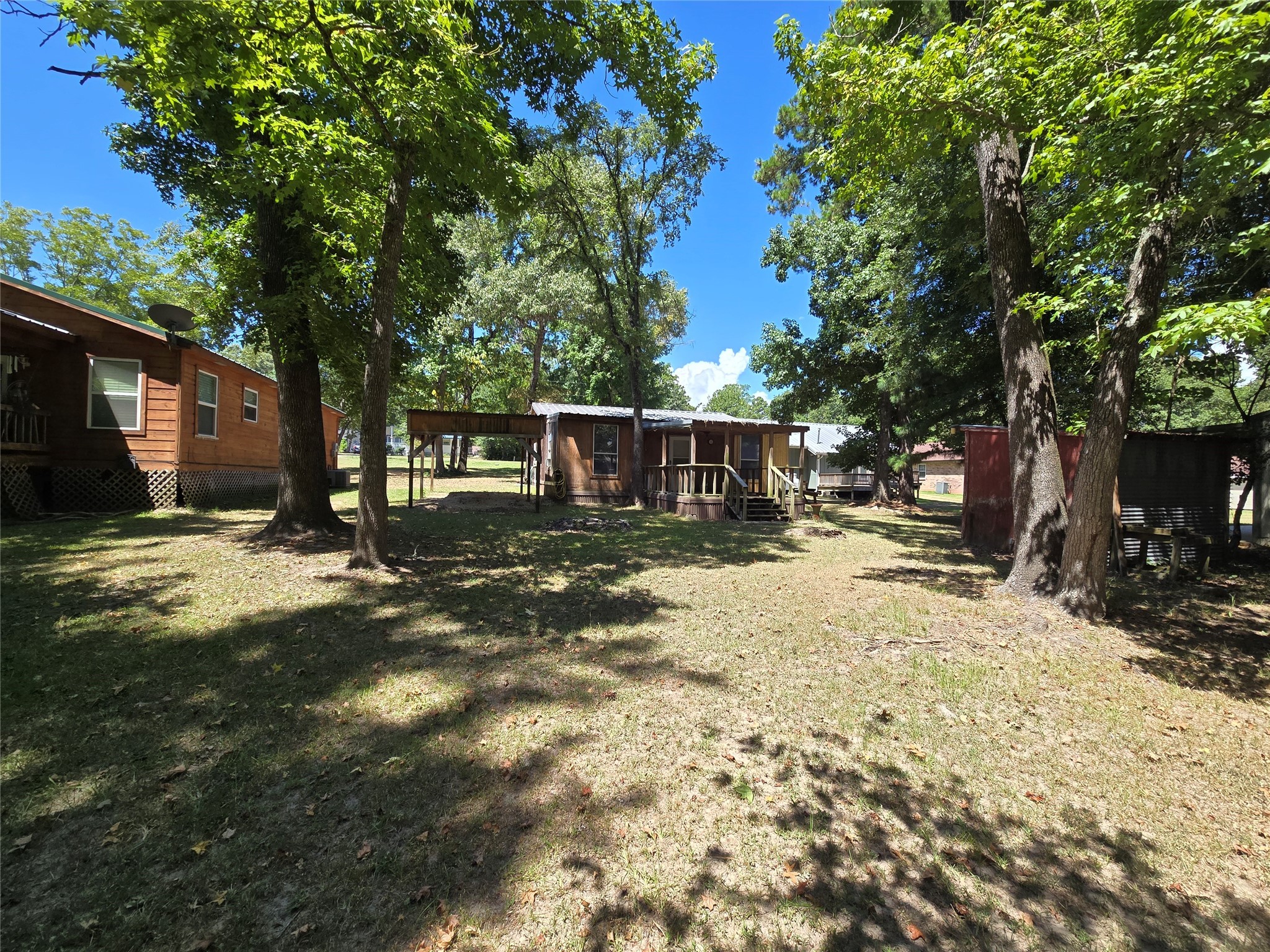 206 Tallow Street Onalaska, TX 77360 - Photo 16 of 25 a view of a backyard with a large tree