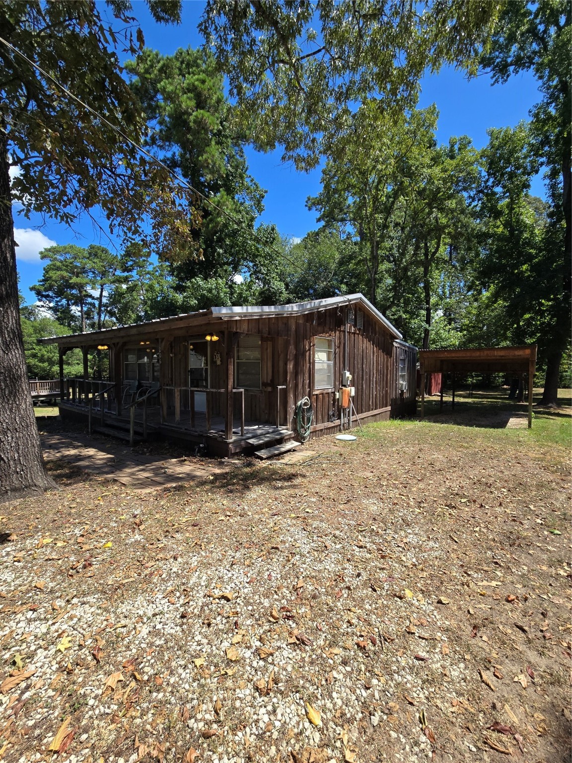 206 Tallow Street Onalaska, TX 77360 - Photo 18 of 25 a view of house with backyard and trees