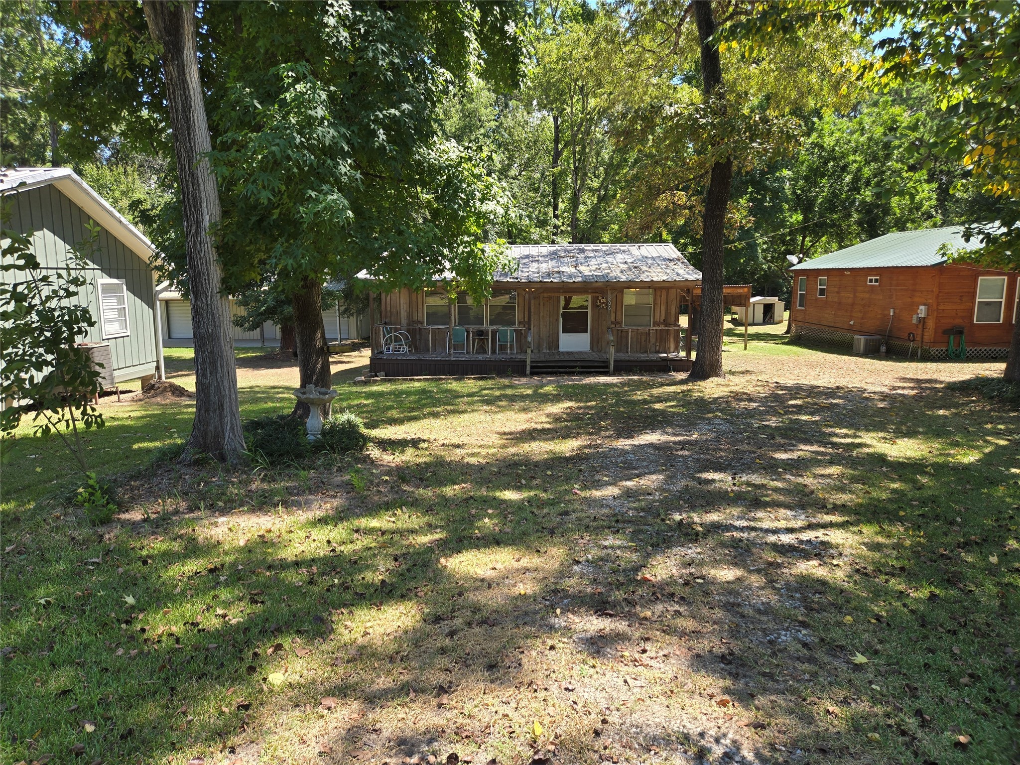 206 Tallow Street Onalaska, TX 77360 - Photo 2 of 25 a view of a house with a yard garage and sitting area