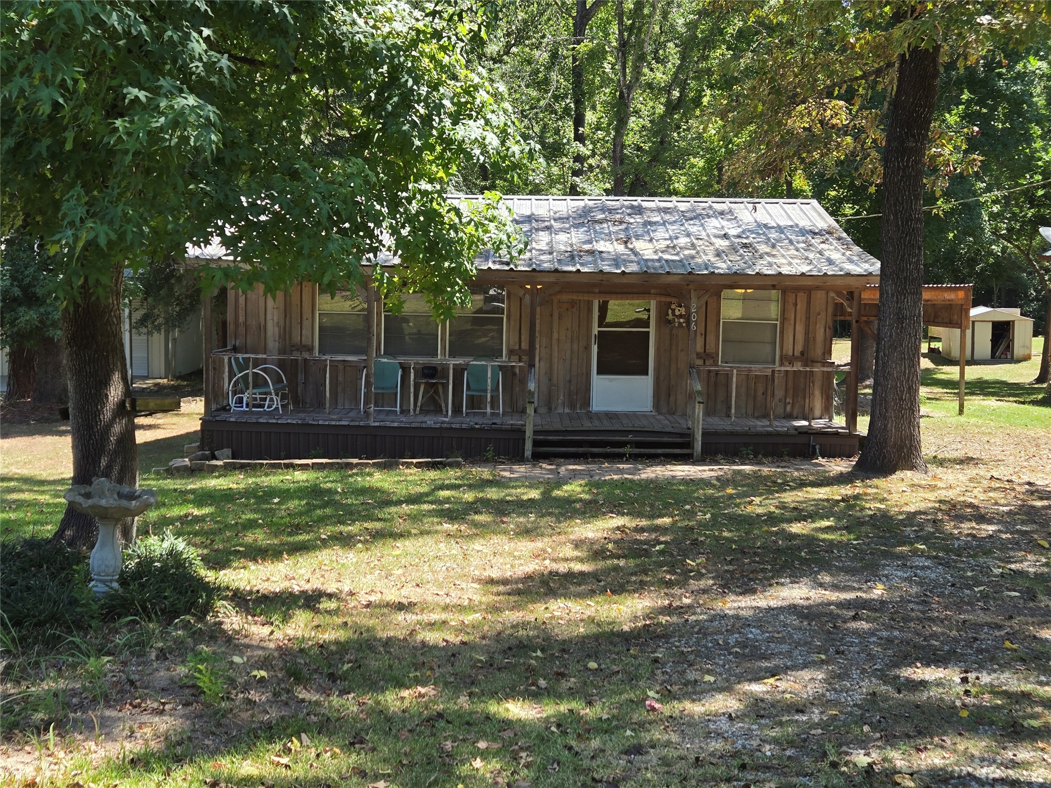 206 Tallow Street Onalaska, TX 77360 - Photo 24 of 25 a view of a house with a yard