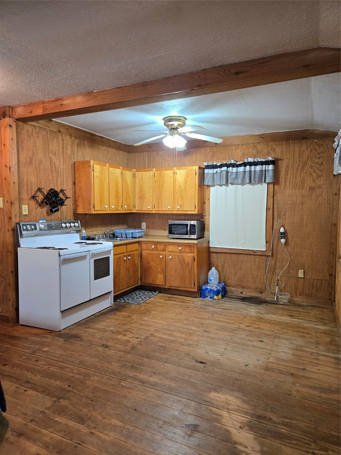 206 Tallow Street Onalaska, TX 77360 - Photo 4 of 25 a kitchen with stainless steel appliances granite countertop a stove a sink and a microwave