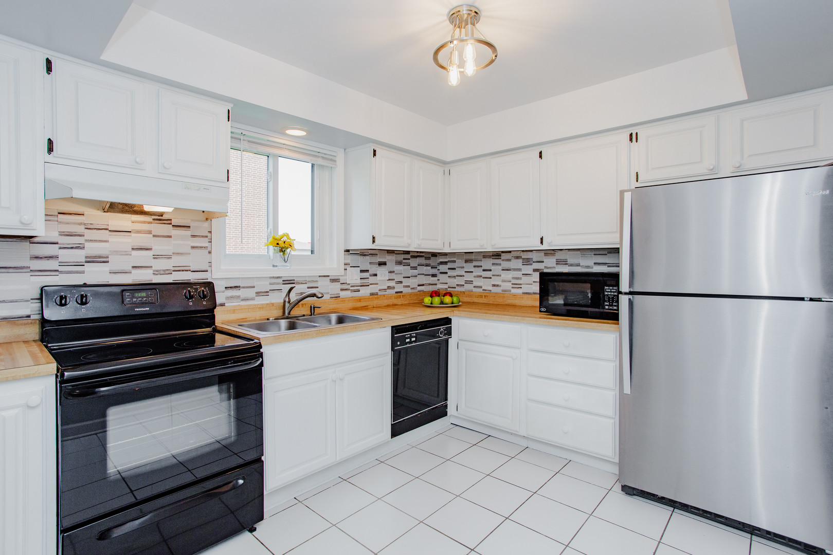 1215 Chalet Road, Unit 101 Naperville, IL 60563 - Photo 11 of 36 a kitchen with a refrigerator and a stove