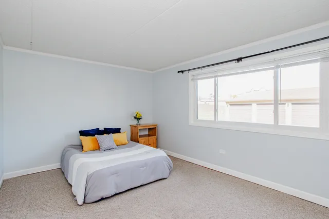 a bedroom with a bed and window