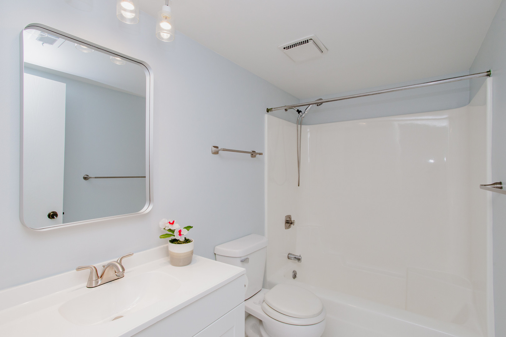 1215 Chalet Road, Unit 101 Naperville, IL 60563 - Photo 17 of 36 a bathroom with a sink vanity mirror and shower
