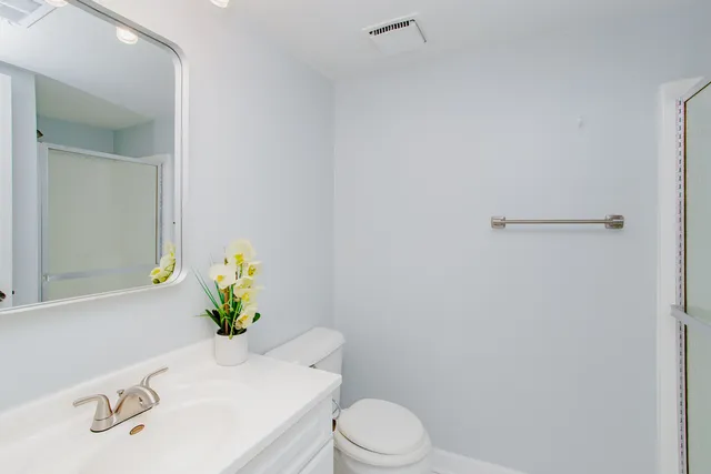 a white toilet sitting next to a bathroom sink