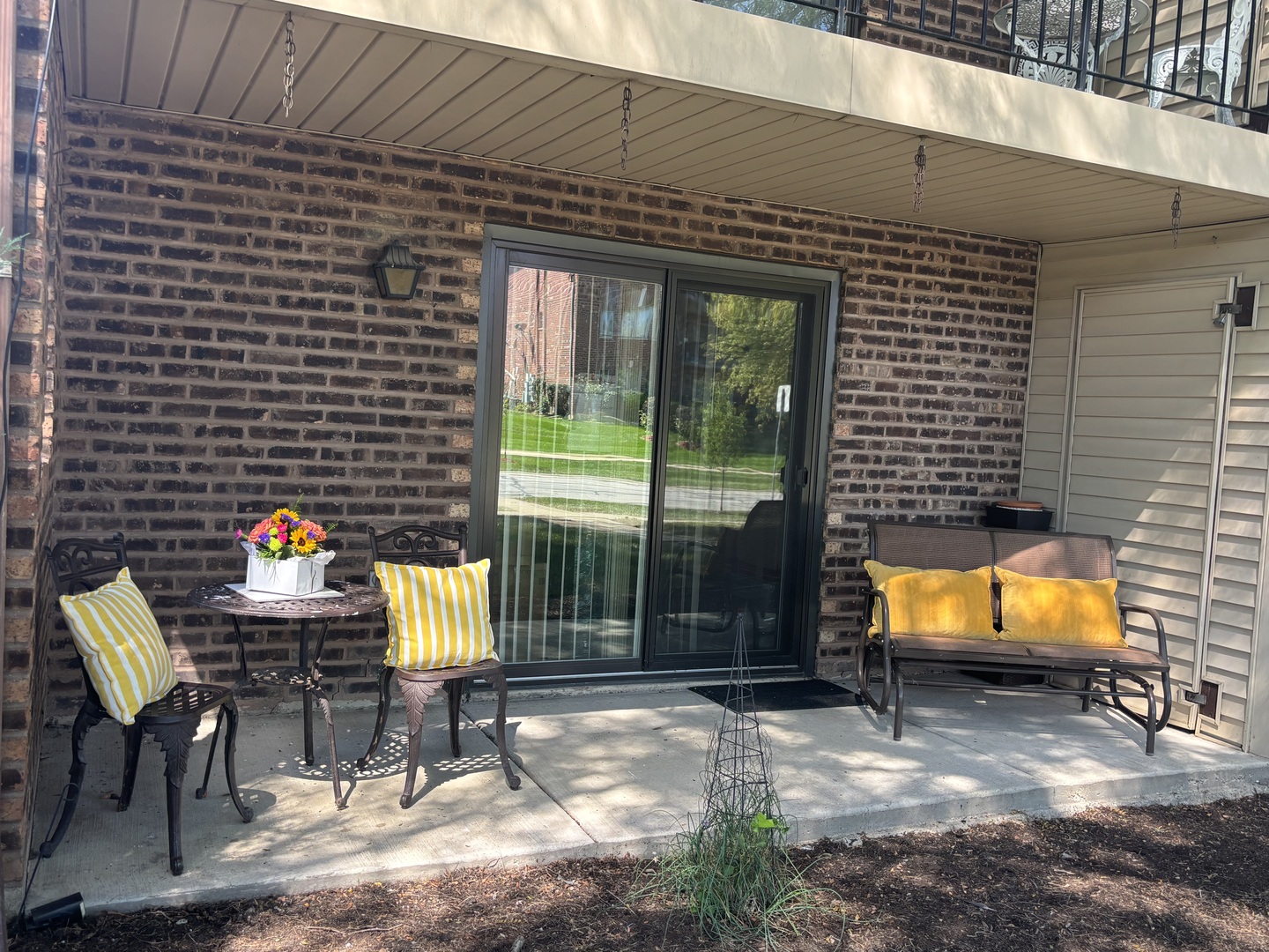 1215 Chalet Road, Unit 101 Naperville, IL 60563 - Photo 2 of 36 a view of a chairs and table in a patio