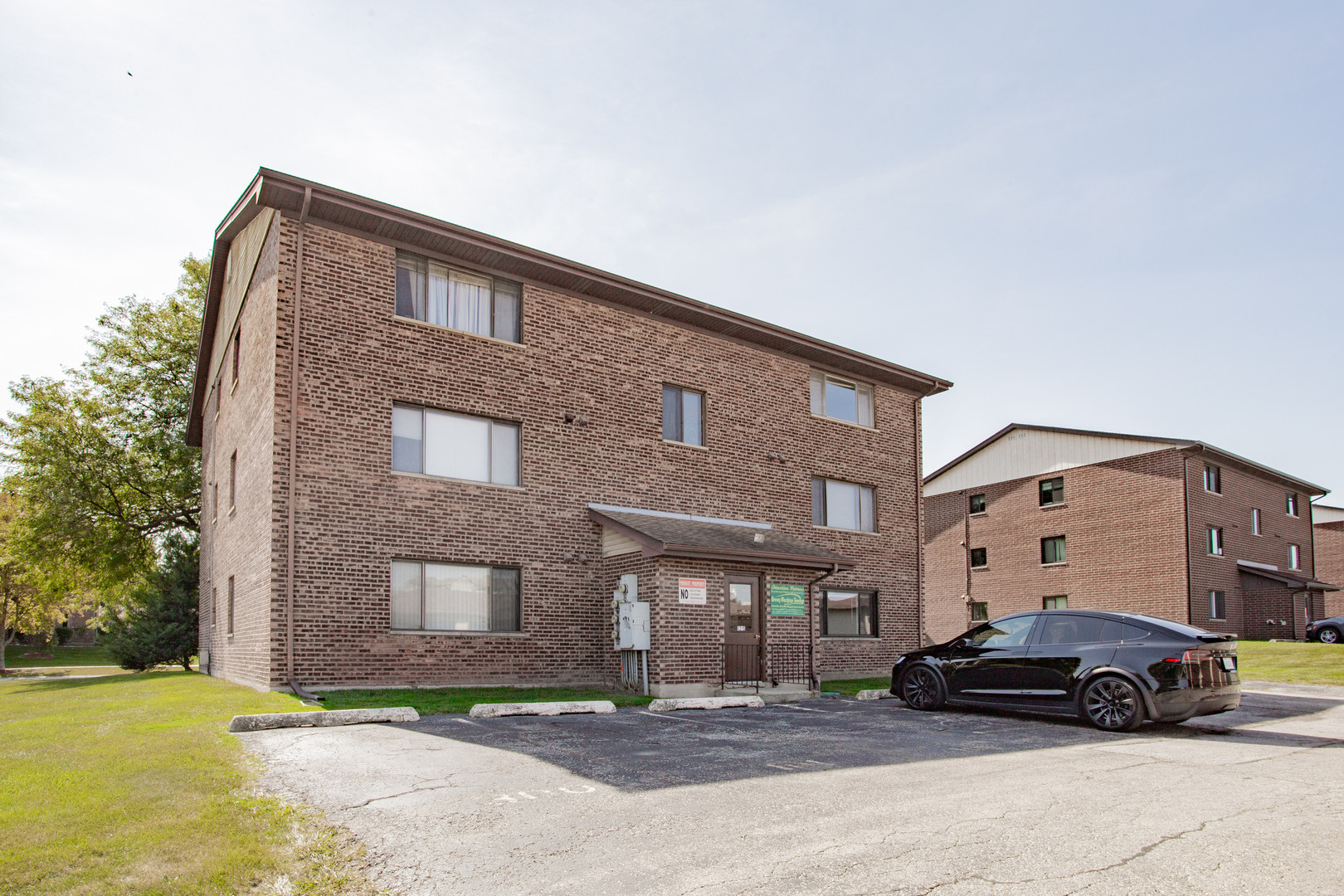 1215 Chalet Road, Unit 101 Naperville, IL 60563 - Photo 23 of 36 a car parked in front of a building