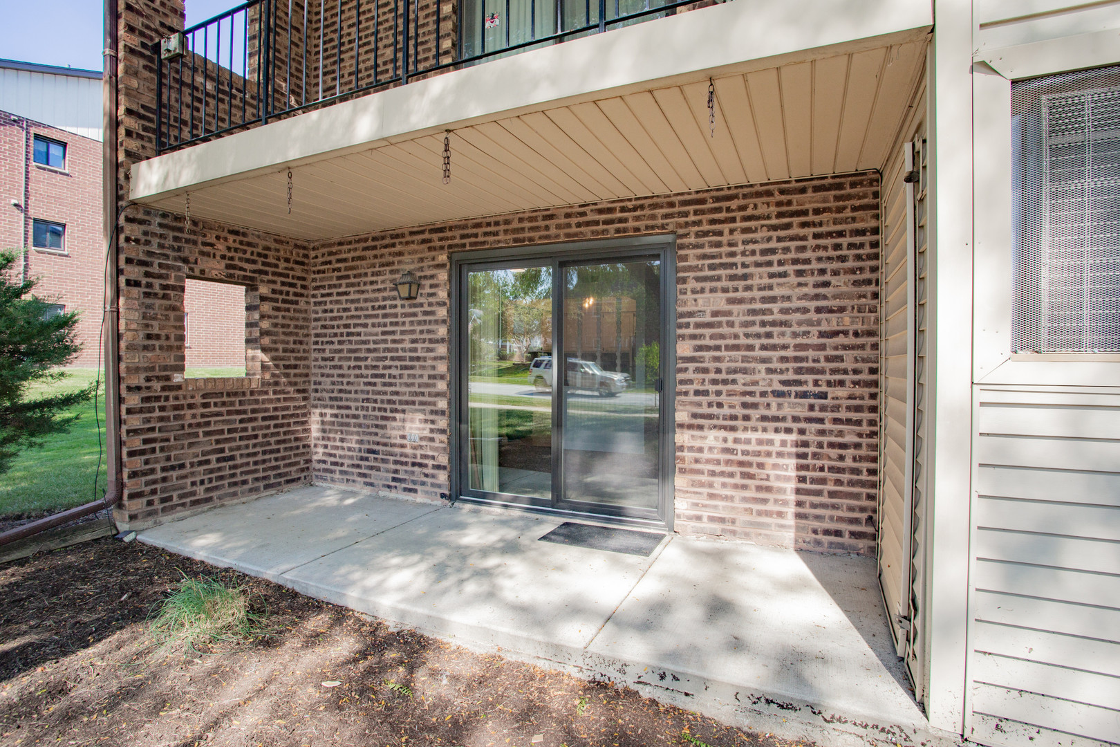 1215 Chalet Road, Unit 101 Naperville, IL 60563 - Photo 3 of 36 a view of a patio with a table and chairs and potted plants