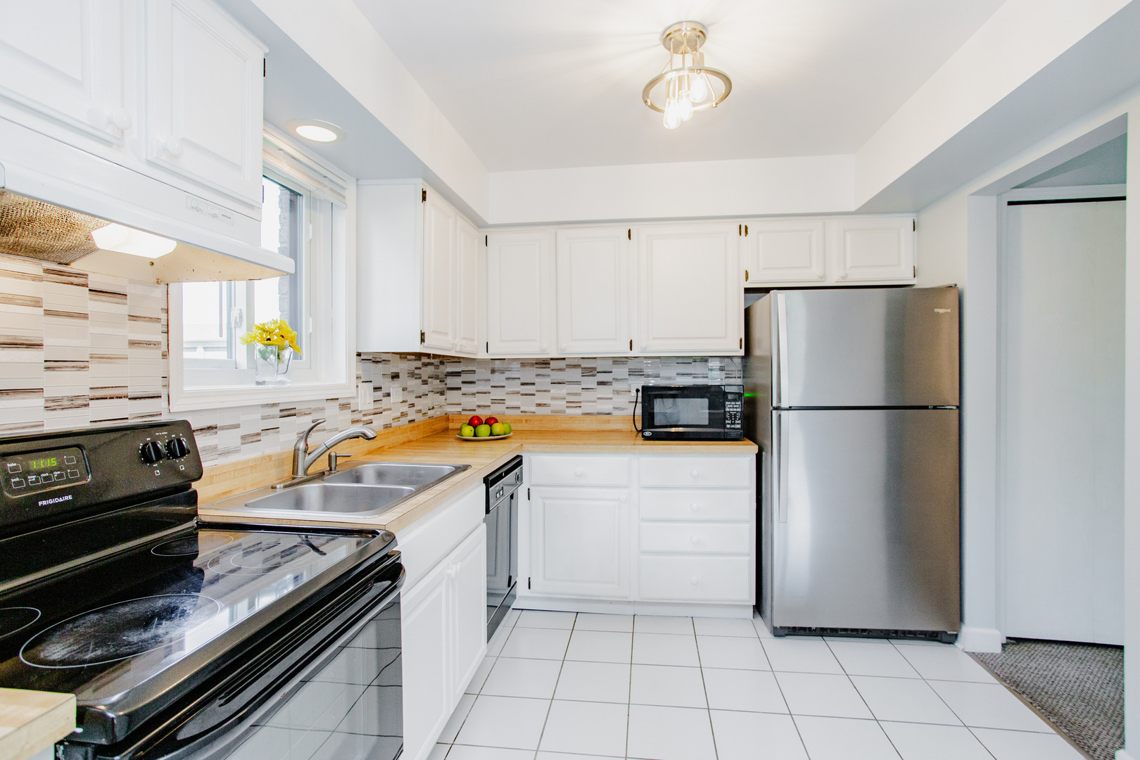1215 Chalet Road, Unit 101 Naperville, IL 60563 - Photo 5 of 36 a kitchen with a refrigerator and a stove top oven