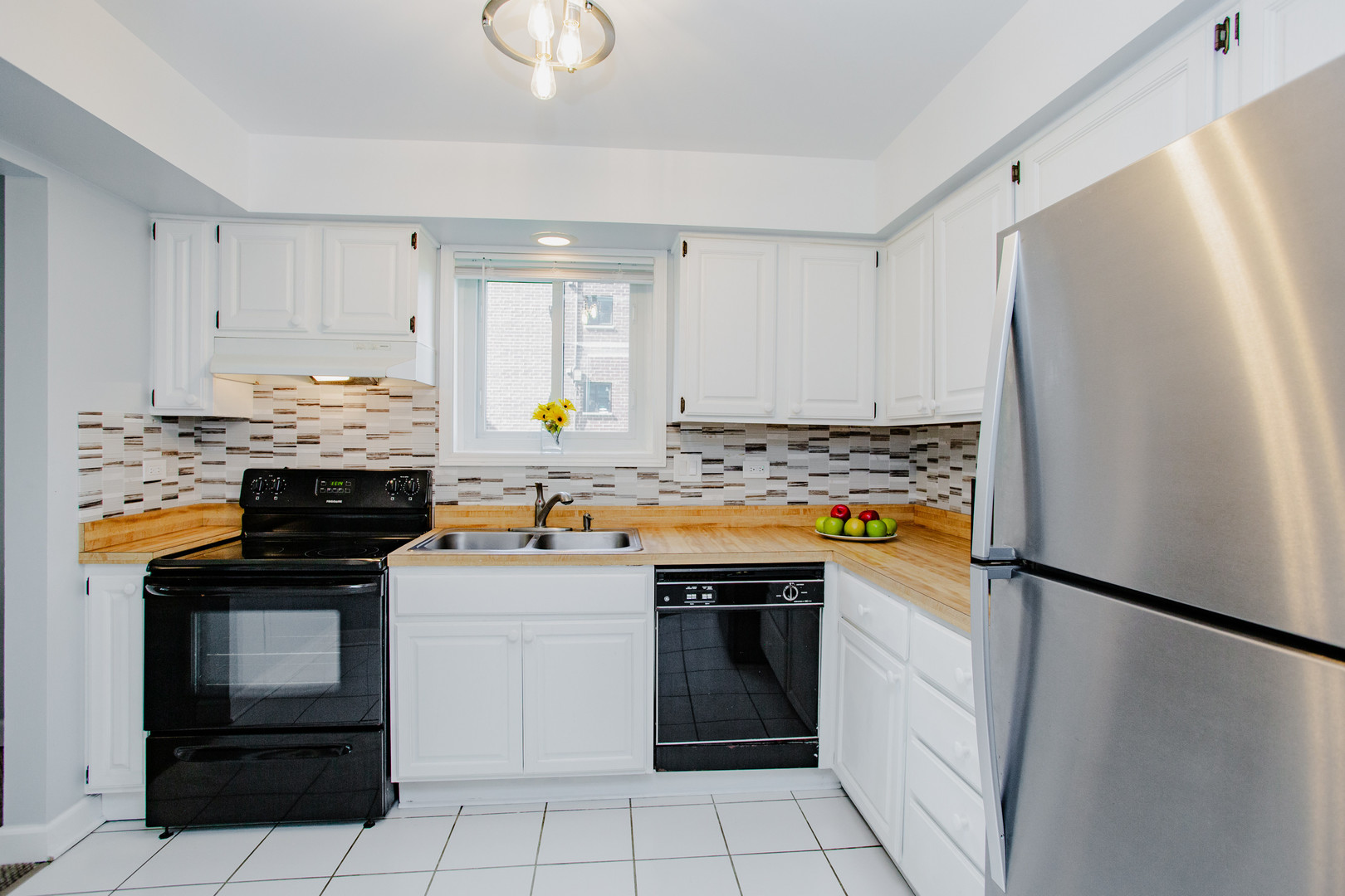 1215 Chalet Road, Unit 101 Naperville, IL 60563 - Photo 6 of 36 a kitchen with stainless steel appliances granite countertop a refrigerator stove and sink