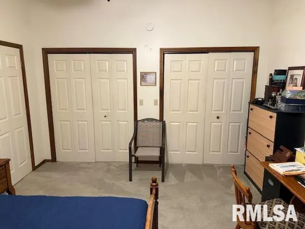 a view of a bedroom with bed and furniture