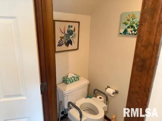 a white toilet sitting next to a bathroom sink and vanity