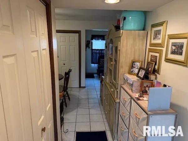 a view of a hallway with living room and furniture